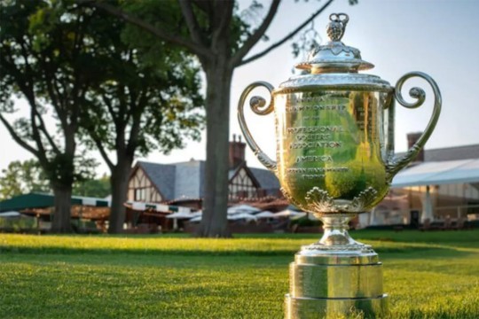 the P G A trophy on the lawn outside of a venue.