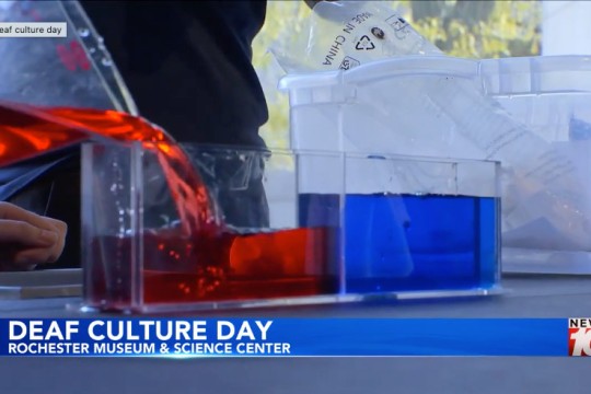 the words deaf culture day appear on screen with a background of a science experience.