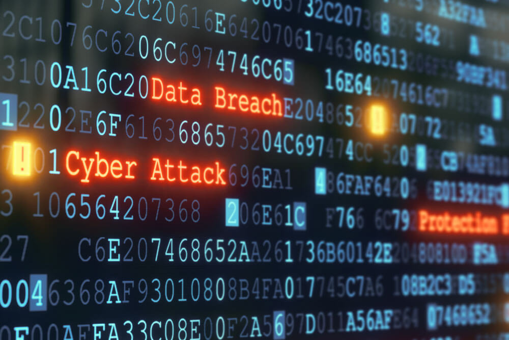 A large blue display of letters and numbers shows 'Data Breach' and 'Cyber Attack' in red.