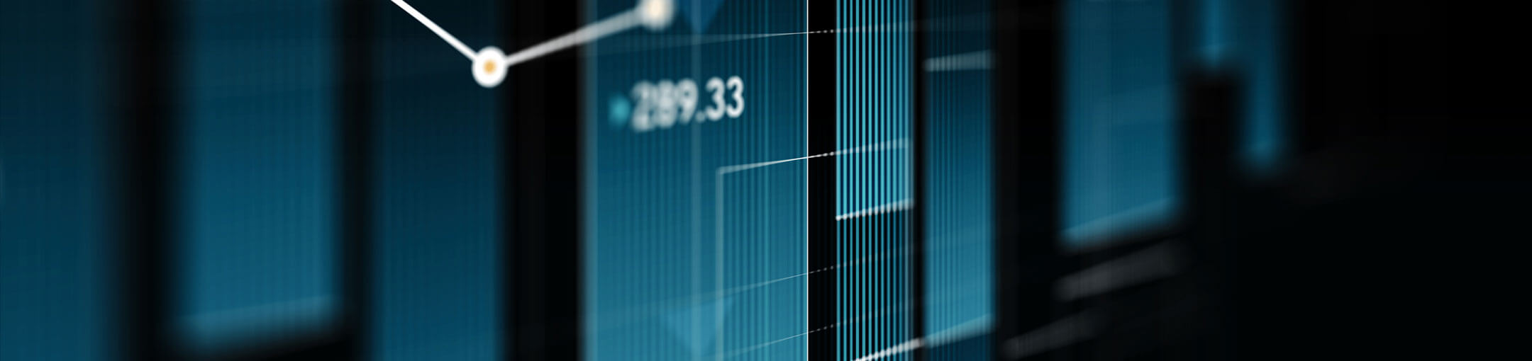 A light blue chart displaying a line graph shines in a dark room.