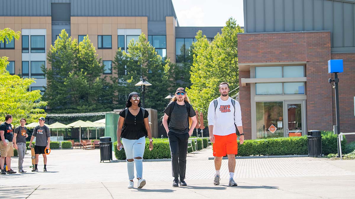R I T students walking around Global Village.