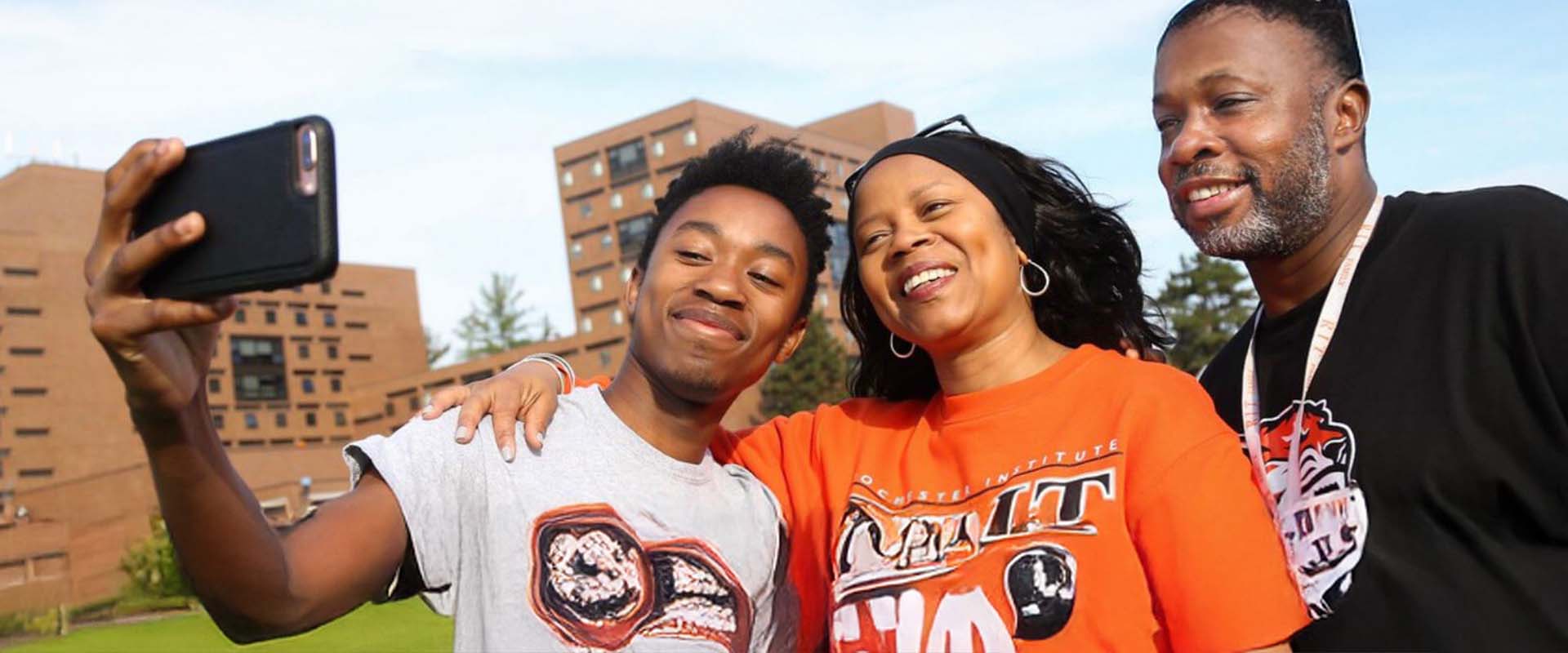 A family taking a selfie during an on-campus event.