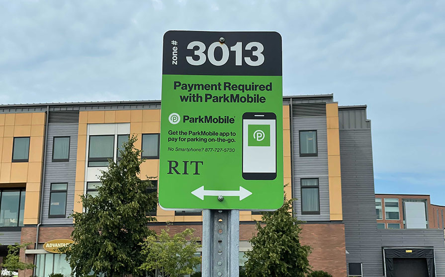 Picture of a ParkMobile sign in a parking lot; the sign contains a zone number and instructions for using ParkMobile.