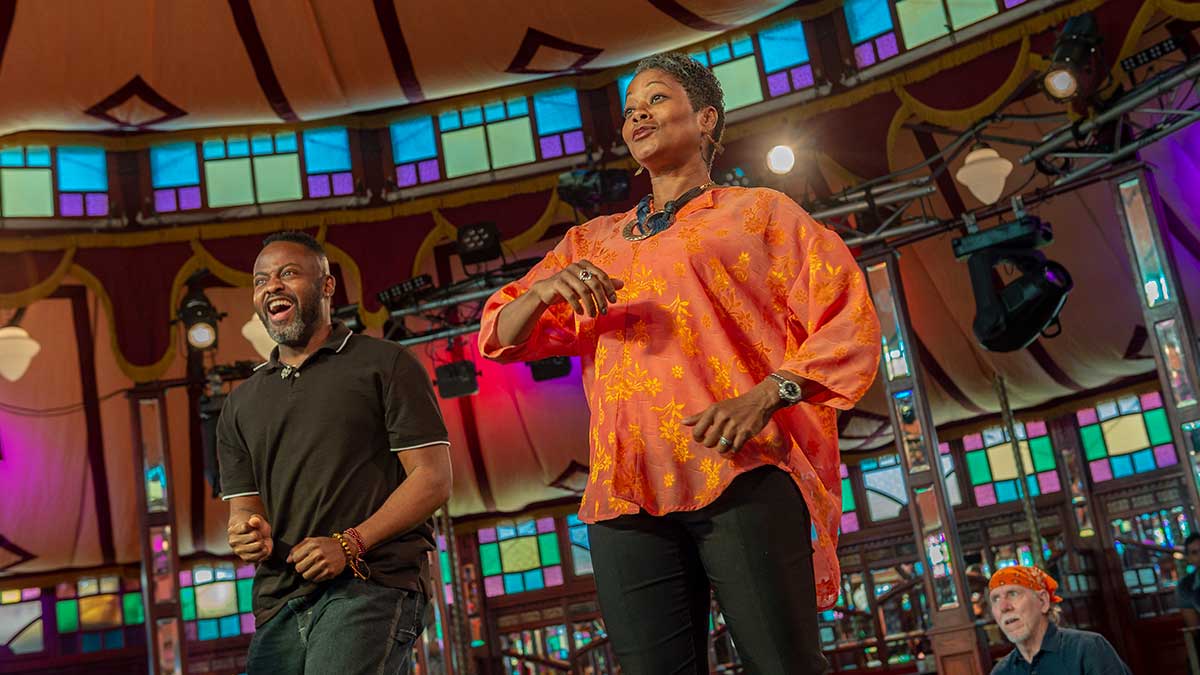 two people performing a skit on a round stage.