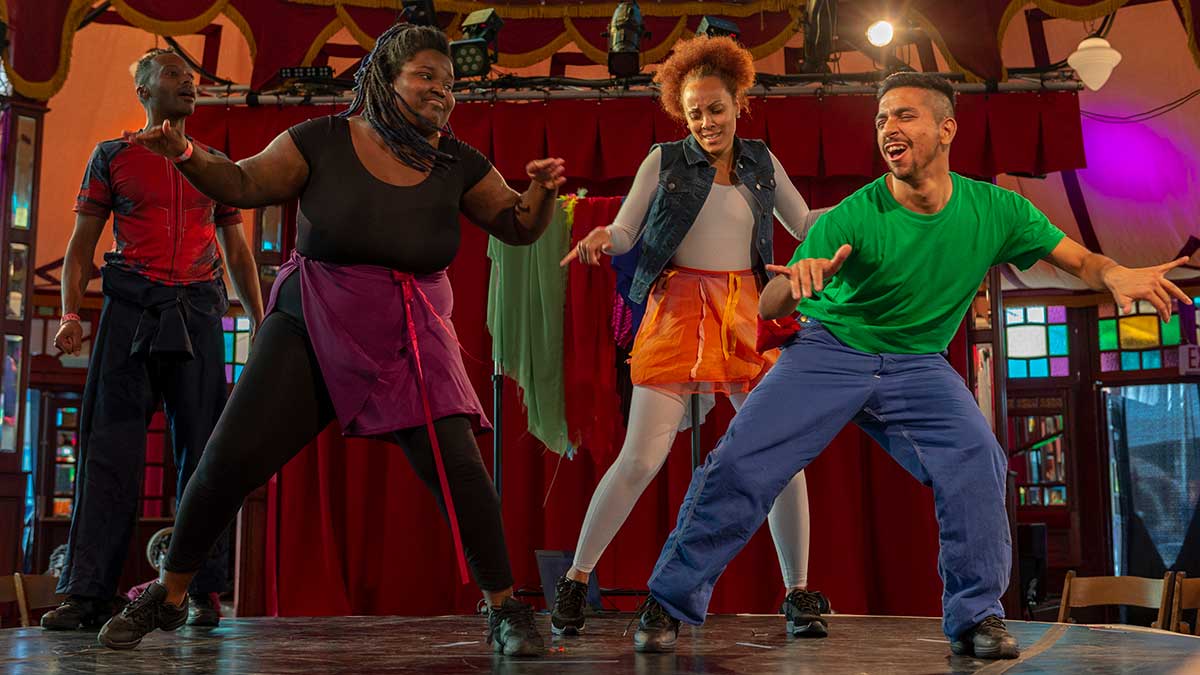 four dancers on stage dance and perform in American Sign Language.