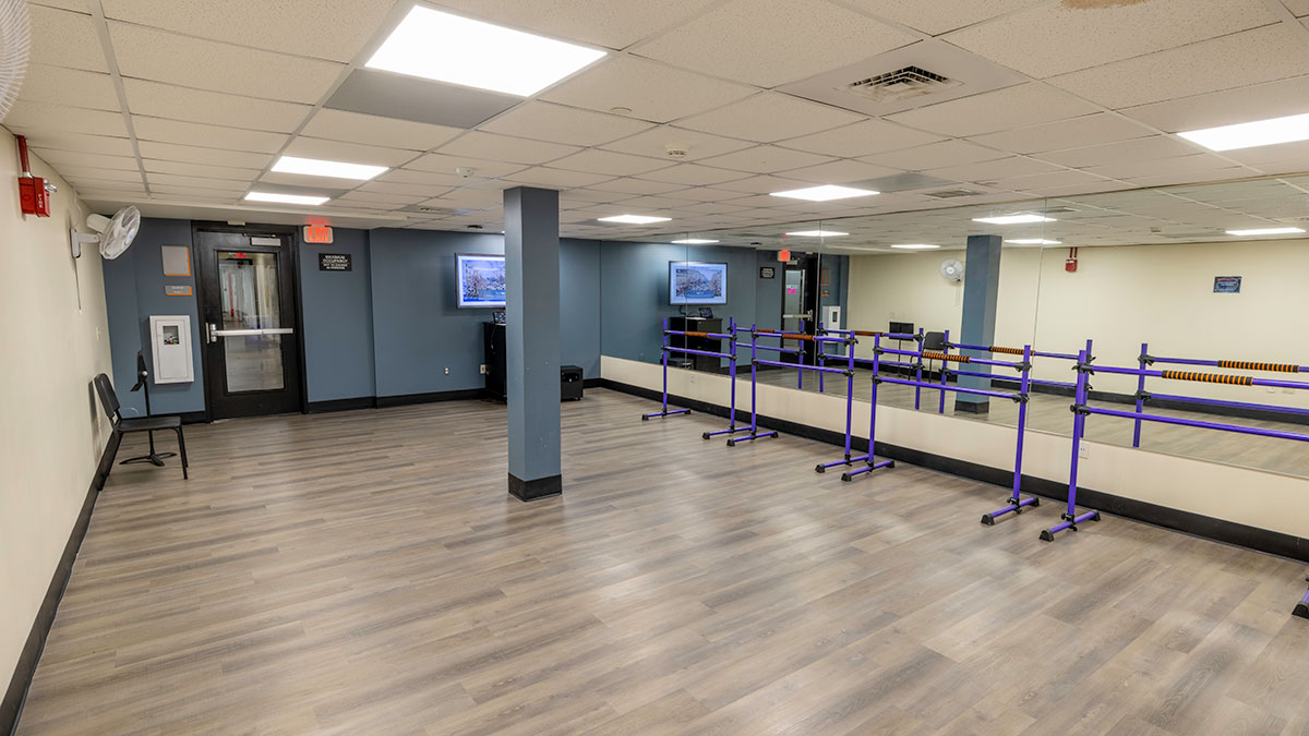 a rehearsal space with mirrored walls and individual barres.
