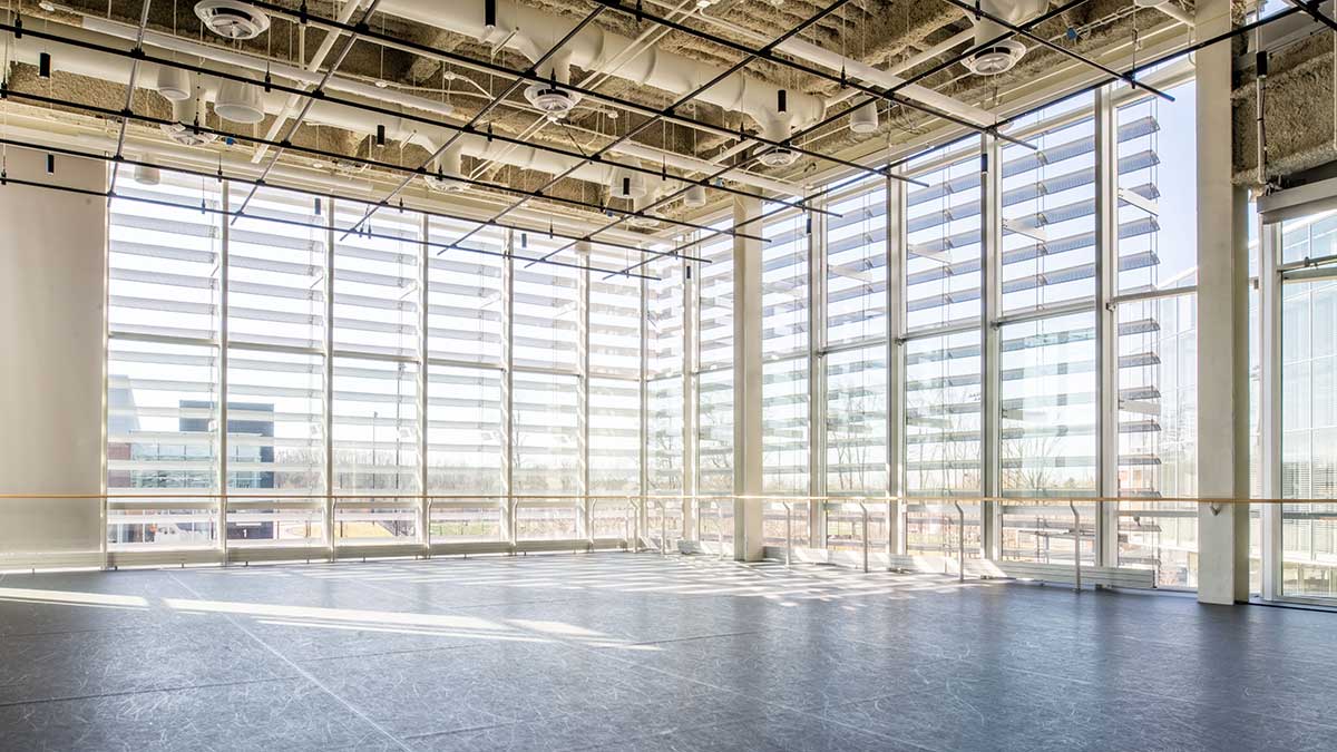a large, empty studio space with windowed walls.