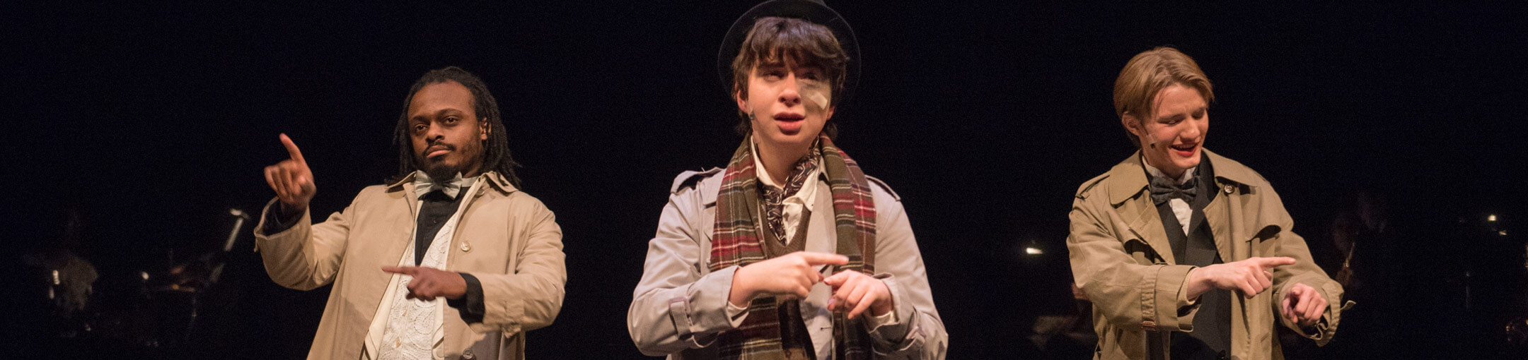 Three RIT students performing in a play on stage.