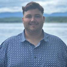 Jake standing in front of a lake.