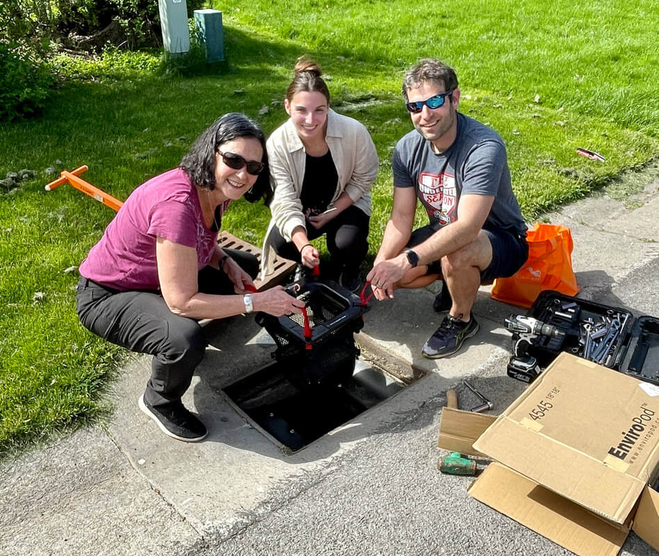 Christy Tyler, Paige Arieno, and Matthew Hoffman installing a LittaTrap device.