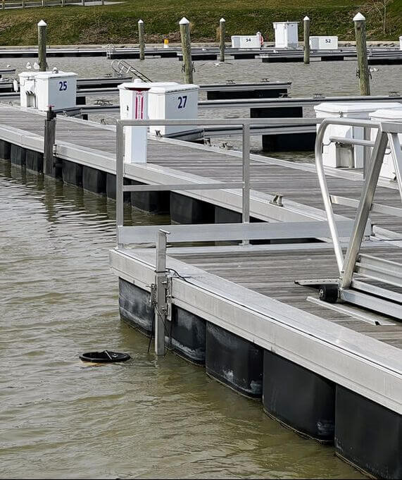A seabin, anchored to a dock, skimming debris from Irondequoit Bay.