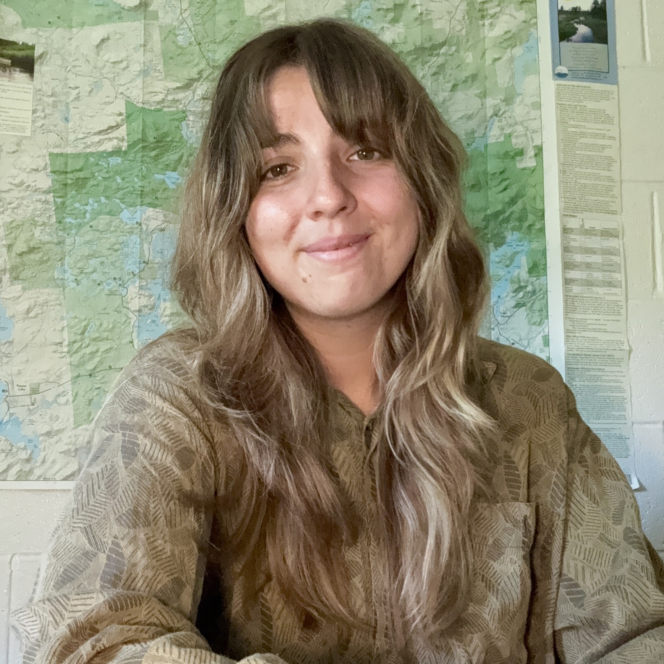 Asha in front of a map.