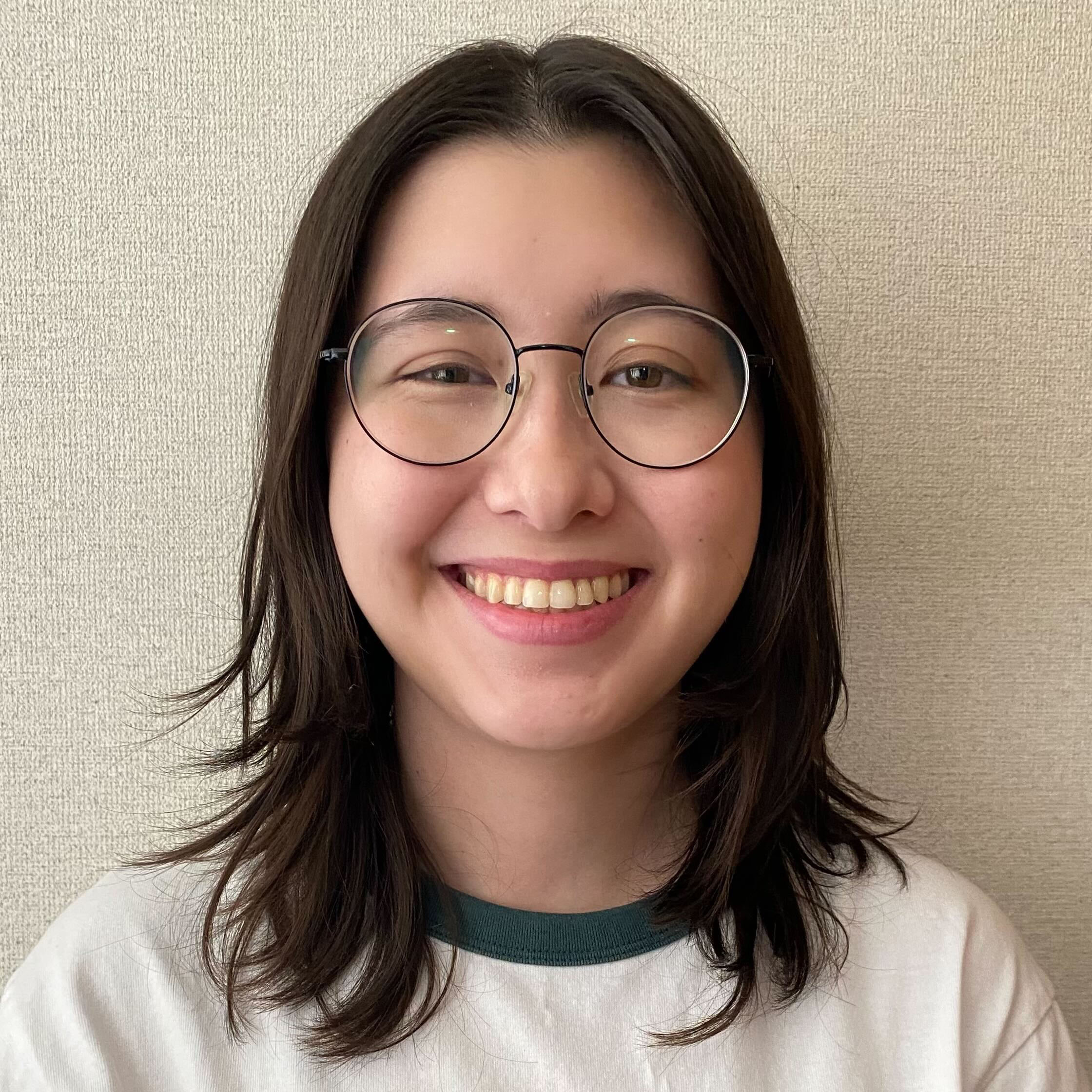 Hana in front of a white wall