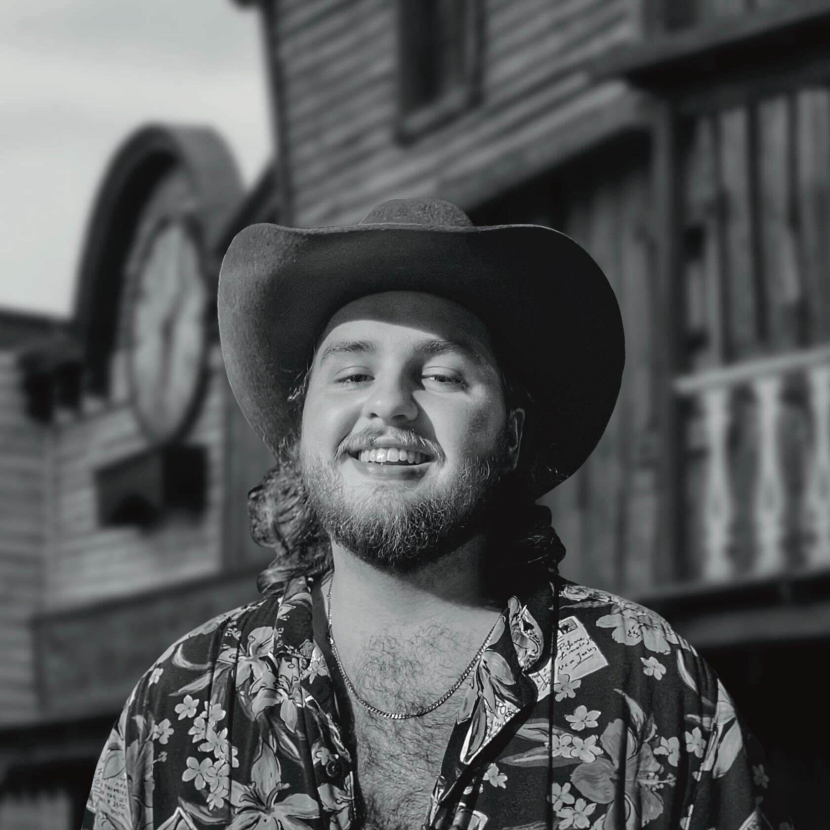 Jayson Kucharek smiling, wearing a cowboy hat.