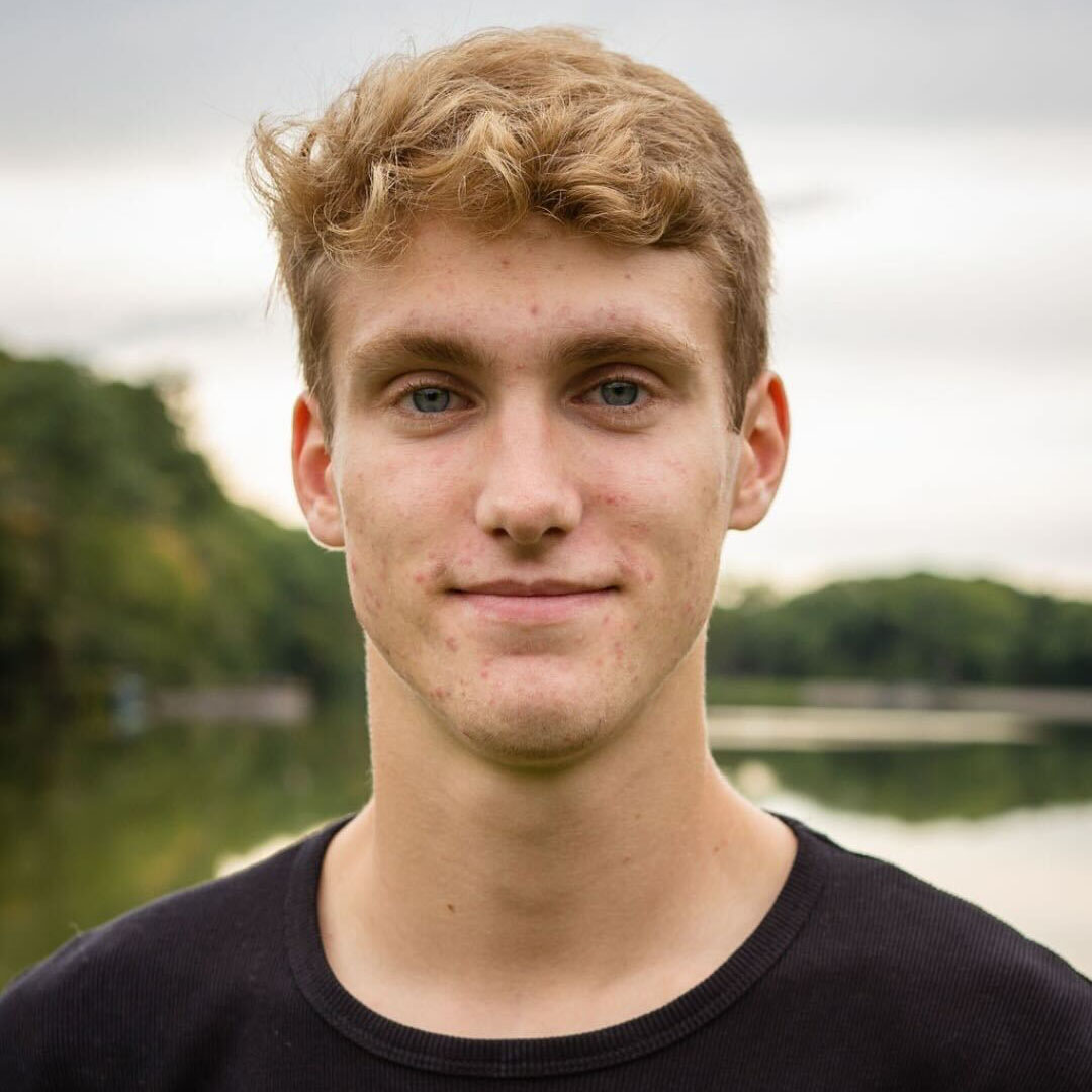 Maddox's headshot taken in front of water.