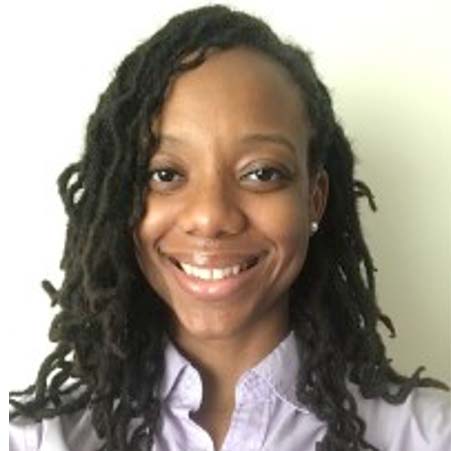 Mechelle smiling against a white bachground.