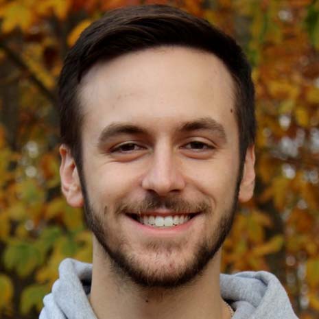 Headshot of Nick in front of a tree.