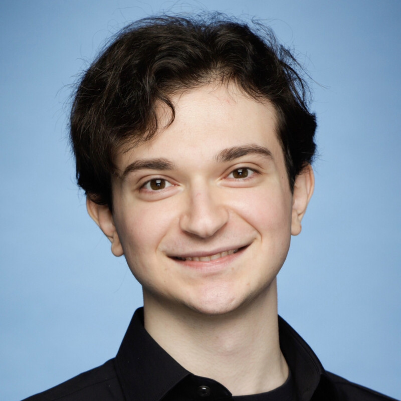 Peter's headshot with a blue background.