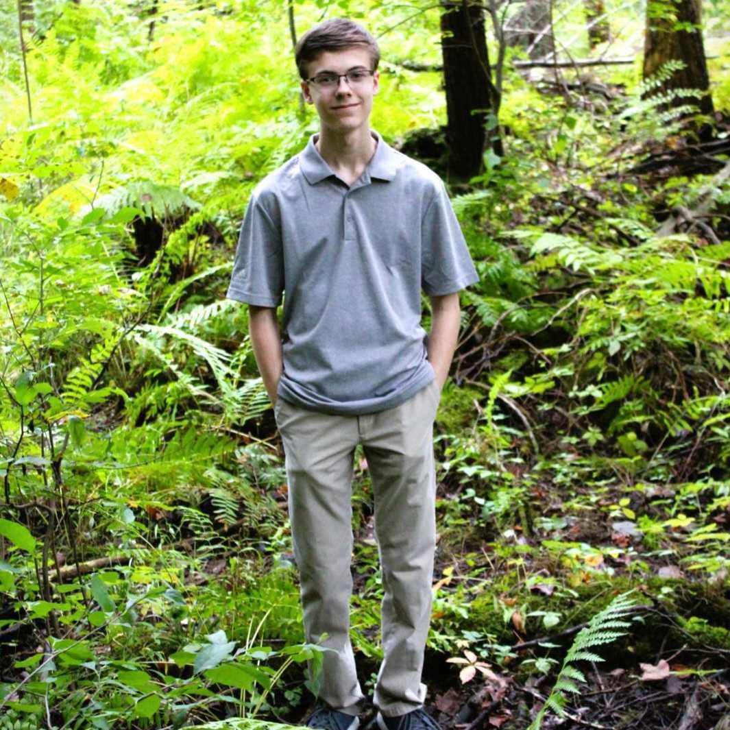 Andrew standing in the woods