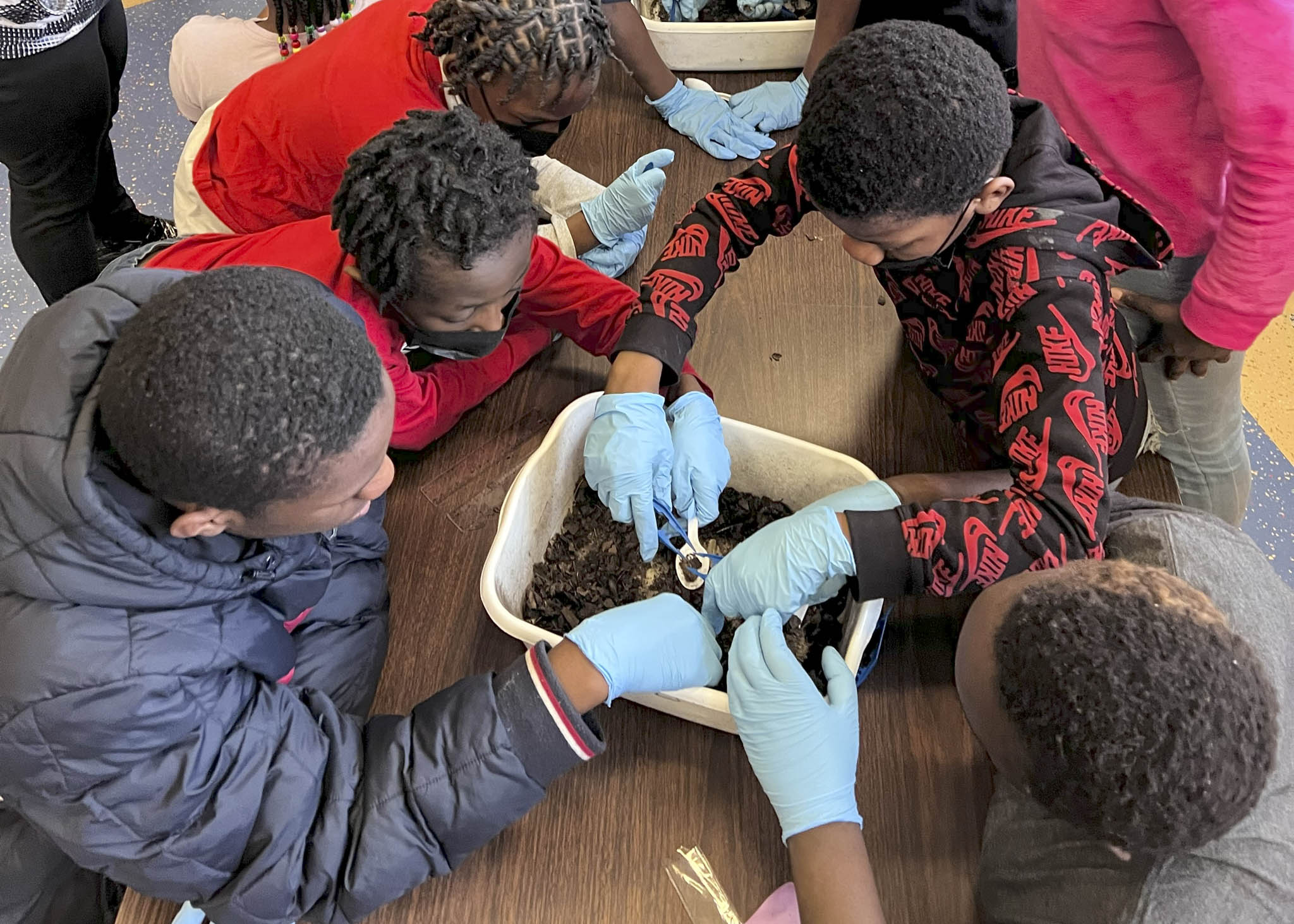 Participants sifting through debris