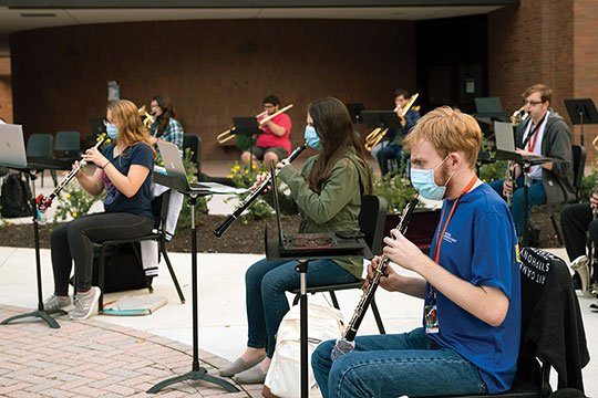 Masked musicians playing instraments.