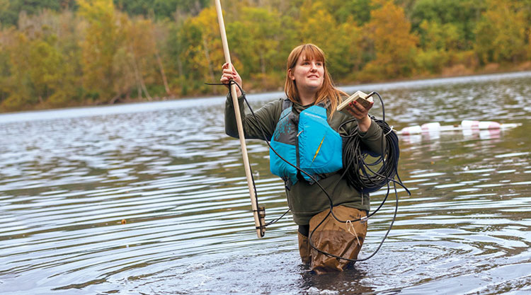 A group of students wearing masks using a cordless drill.