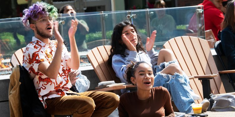 A group of students wearing masks using a cordless drill.