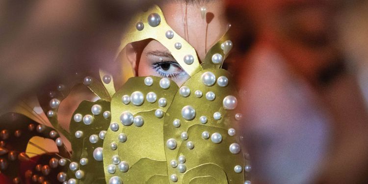 A group of students wearing masks using a cordless drill.