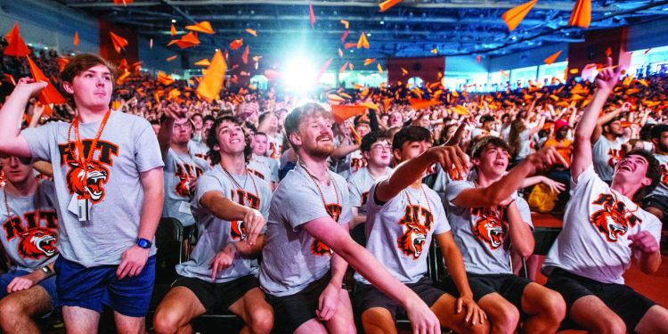 A group of students wearing masks using a cordless drill.
