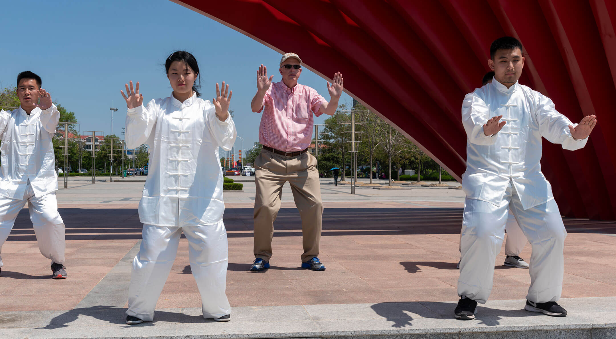 President Munson performing with a group wearing white clothing
