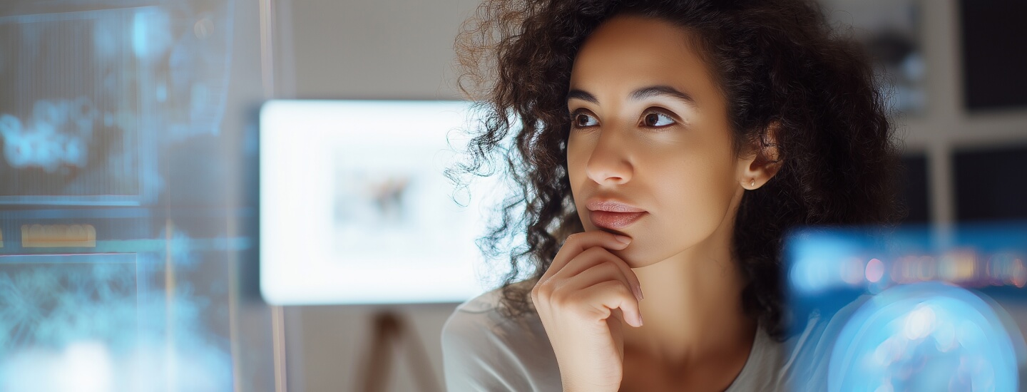 A woman looking off to the side, with her hand on her chin.