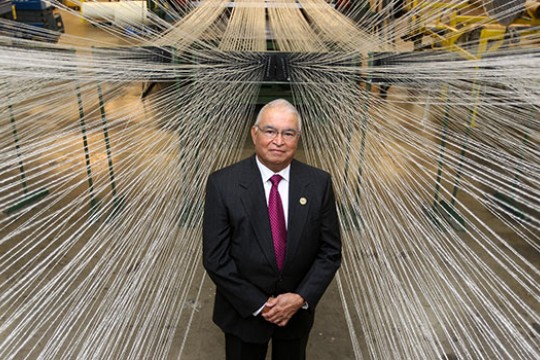 Bal Dixit standing in front of a wall of wire