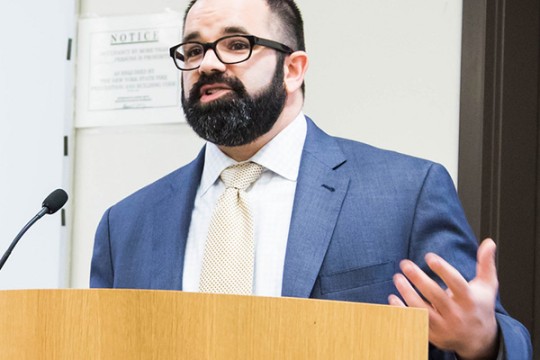 Dr. David Reidmiller standing at podium