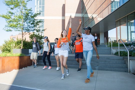 two students high-fiving.