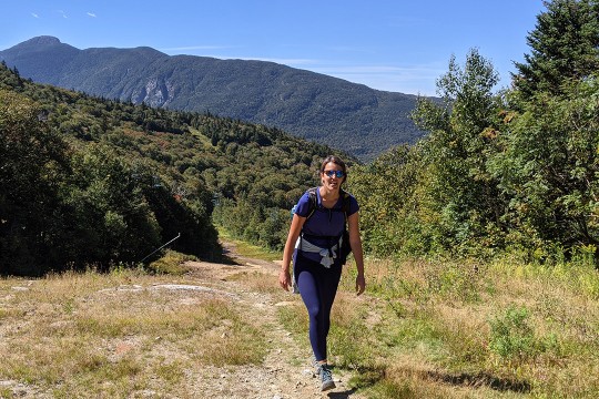 woman on a hiking trail in the mountains.