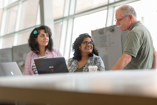 two students looking at a professor.