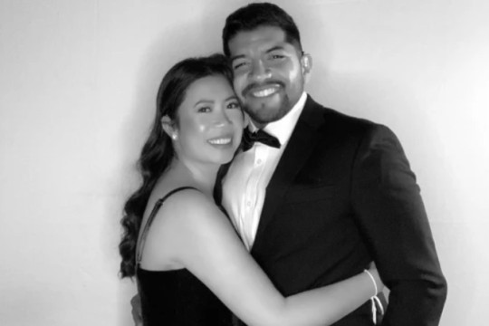 man and woman hugging, posing for a photo.