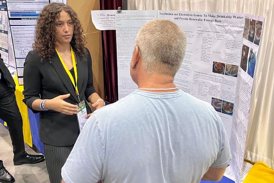 student talking with judge at science fair