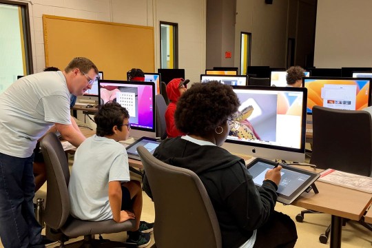 Professor working with art students