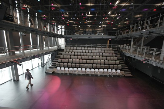 stadium style seating in an empty theater space.