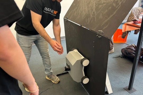 Image showing students demonstrating a hull-cleaning robot prototype at R I T
