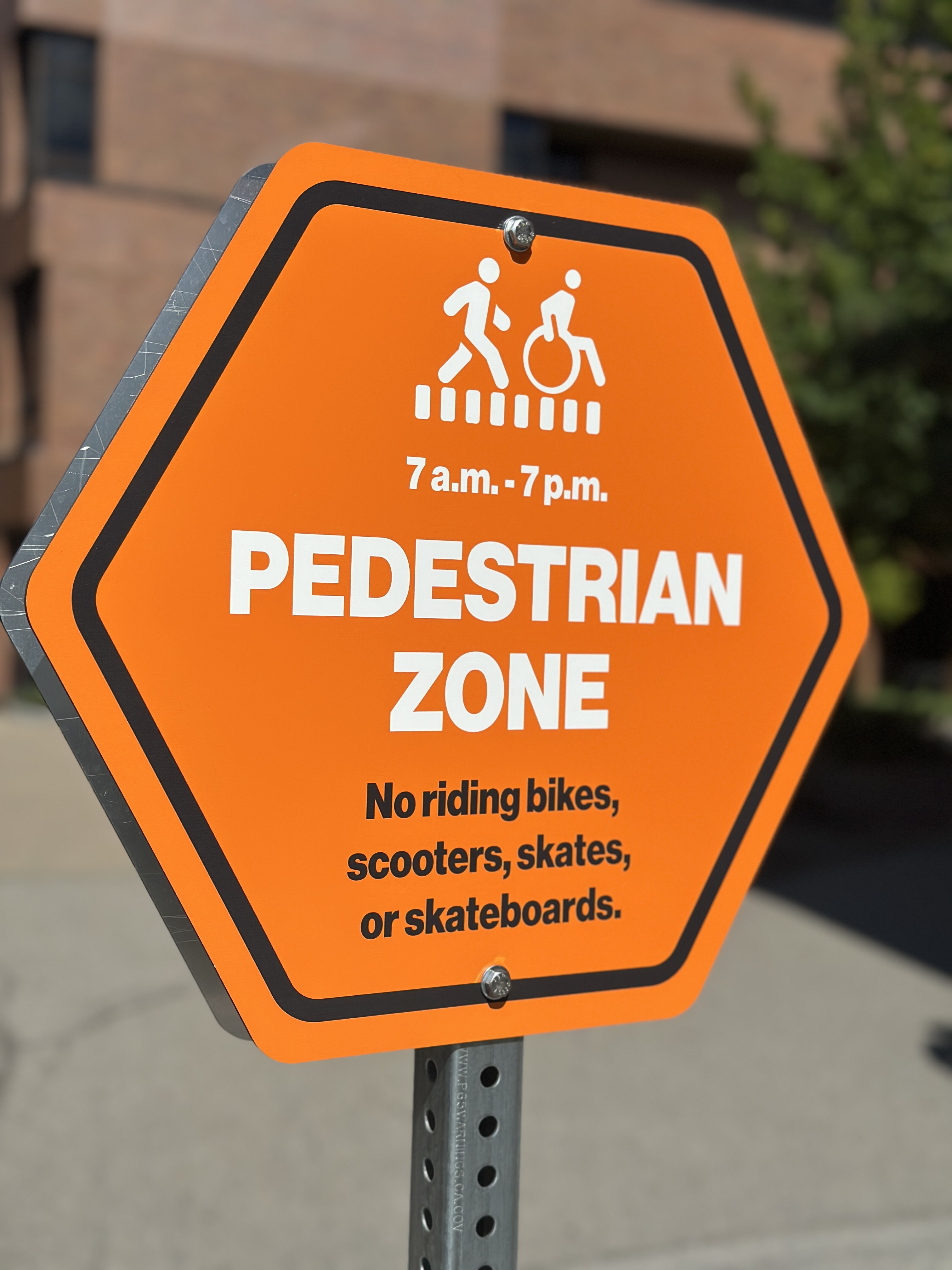 orange sign on walkway