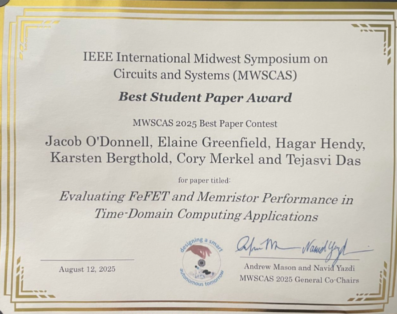 Photograph of the Best Student Paper Award. The certificate is white, with gold on the edges. 