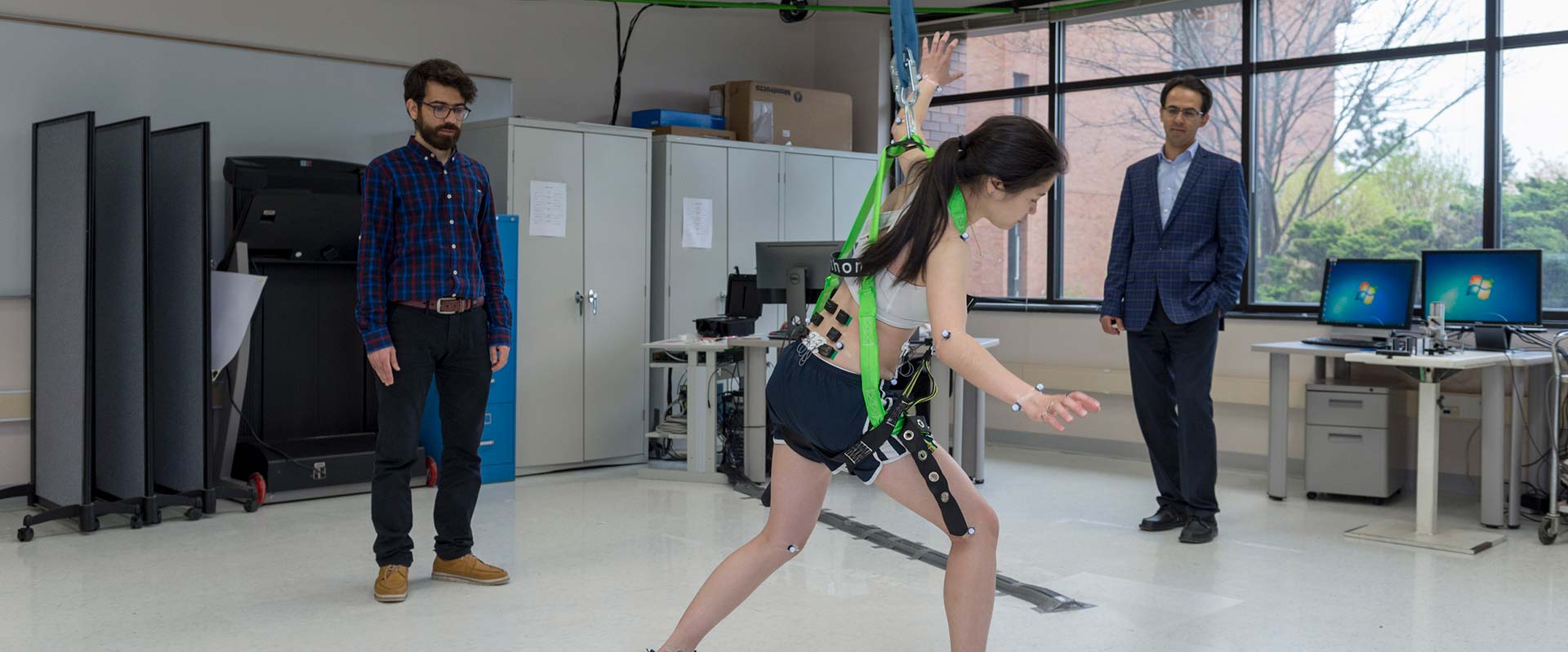 Student walking across the lab with motion detection sensors on.