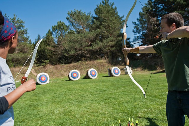 Two students shooting at targets on the archery range.
