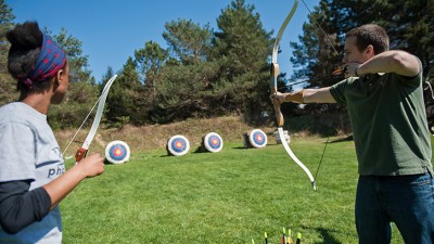 Two students shooting at targets on the archery range.