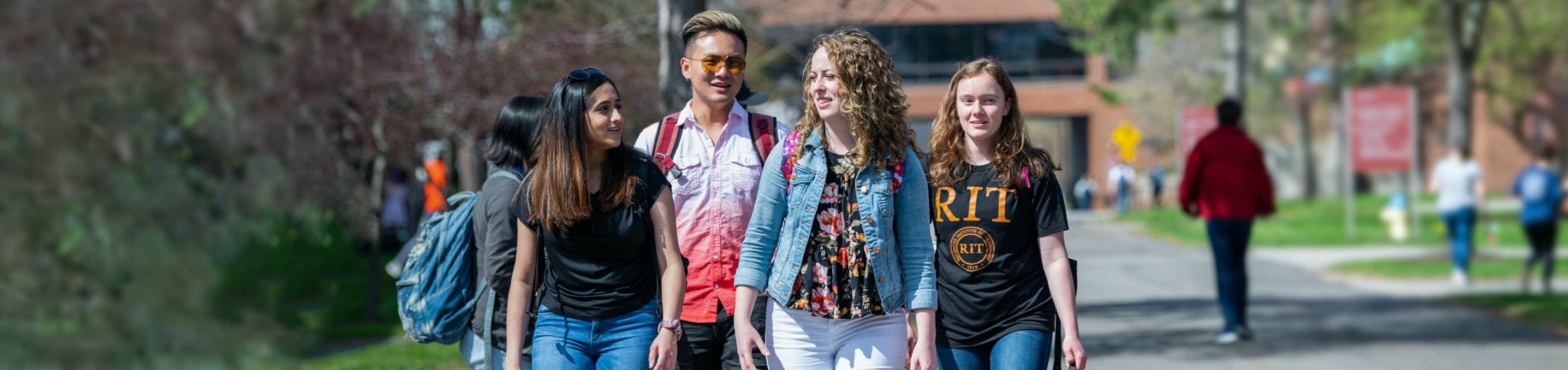 students walking in a group across campus