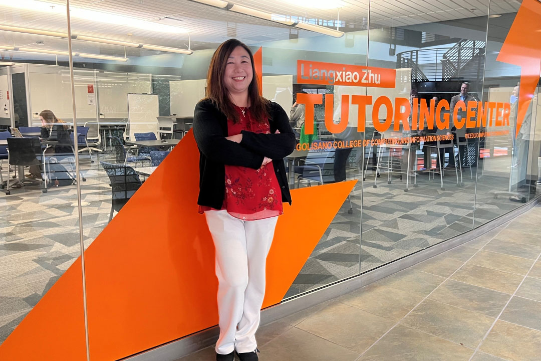 RIT alumna Liangxiao Zhu stands in front of their namesake tutoring center.