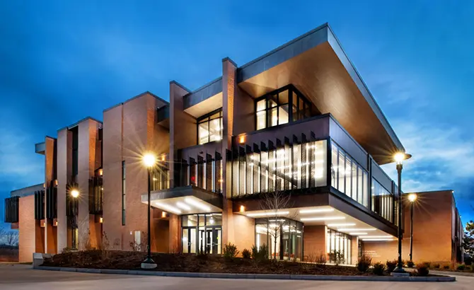 the outside of the RIT Saunders building lit up at night