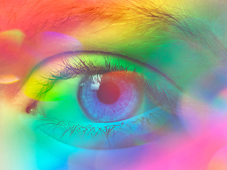 close up picture of an eye with color spectra